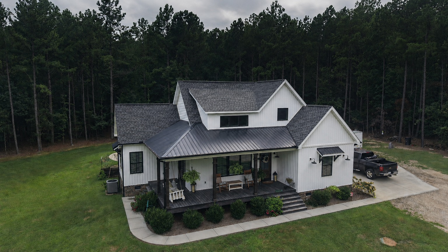 White residence and wooded grounds photographed from above